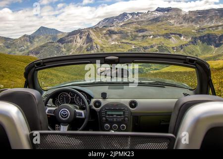 Grossglockner, Austria, August 20, 2020: Mazda MX-5 NC cockpit view with beautiful mountain scenery in the background. Stock Photo