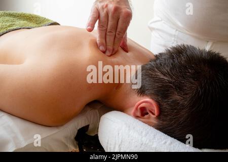 A Nineteen Year Old Teenage Boy Having A Back Massage Stock Photo