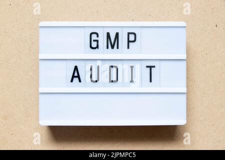 Lightbox with word GMP (Good manufacturing practice) audit on wood background Stock Photo