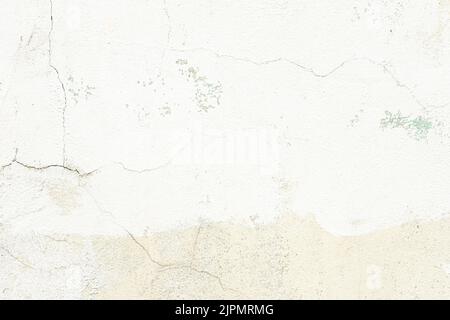 White plaster wall texture with crack background. Pattern of white plaster wall in rough aged structure Stock Photo