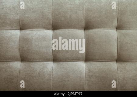 Gray suede leather background for the wall in the room. Interior design, headboards made of furniture fabric, furniture upholstery. Classic checkered Stock Photo