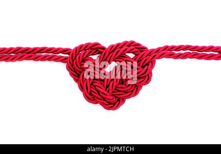 Heartbeat symbol made from braided red cord isolated on white background. Creative healthcare concept. Stock Photo