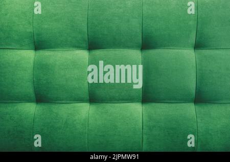 Green suede leather background for the wall in the room. Interior design, headboards made of furniture fabric, furniture upholstery. Classic checkered Stock Photo