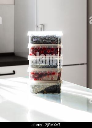 Ripe berries in plastic boxes are ready to be frozen in the freezer. Low Carb Cherry and Honeysuckle are used on the keto diet. Berries are rich in Stock Photo