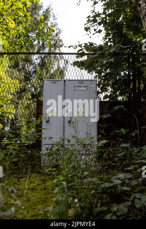 bielsko biala silesia poland 08.16.2022  electrical switchboards in between leaves and tall grass forest forest Stock Photo