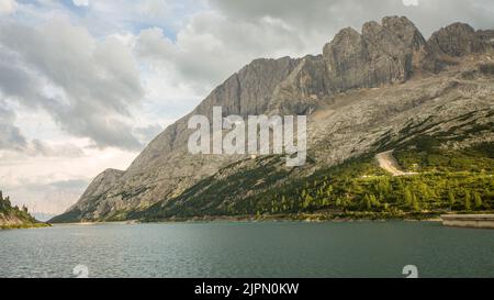 The beautiful panoramic view of Fedaia Lake, Lago di Fedaia, Italian Alps, Dolomites, Dolomiti, Italy, Europe. HD wallpaper, 4k Green background. Stock Photo