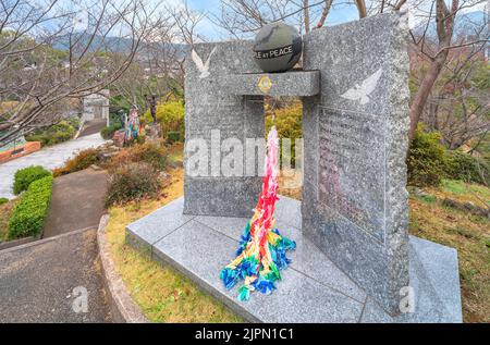 nagasaki, kyushu - december 11 2021: Atomic bomb memorial stone monument called People at peace created in 1984 by Nagasaki Nishi Lions Club adorned w Stock Photo