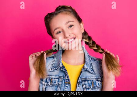 Photo of little blond girl wear t-shirt jeans vest isolated on vivid color background Stock Photo