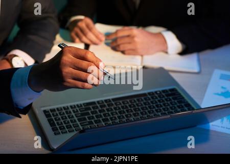 Coworkers discussing important information on screen of laptop Stock Photo