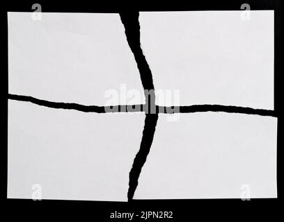 White torn paper on black background Stock Photo