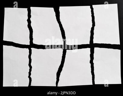 White torn paper on black background Stock Photo