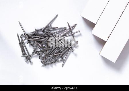 Nails and chipboards, isolated on white background . Text copy space.selective focus Stock Photo