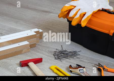 Toolbox With Various Work Tools On A Wooden Floor. Text copy space Stock Photo