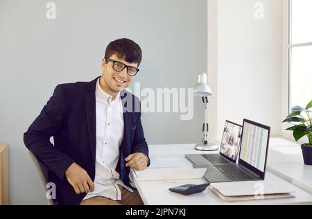 Portrait of a happy young businessman or financial accountant at work in the office Stock Photo