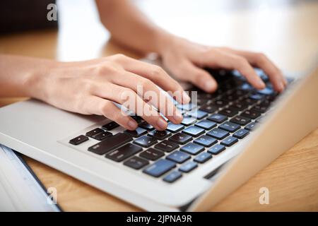 Hands of woman working on laptop on her table Stock Photo