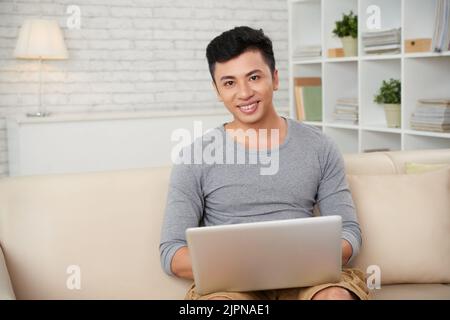 Handsome young businessman working on laptop Stock Photo