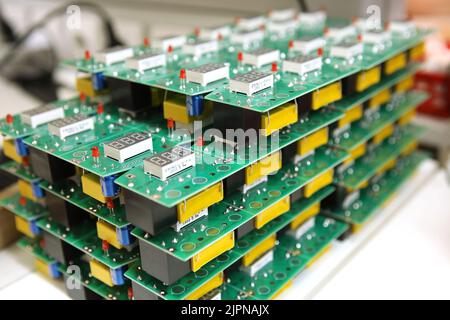 Electrical boards with parts for manual assembly of an electrical device. Digital indication. Manual assembly of radio components.. Stock Photo