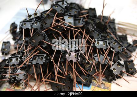 Lots of radios. Loose electronic parts on the table. Digital indicator, LEDs, capacitor and microcircuits in a pile. Stock Photo