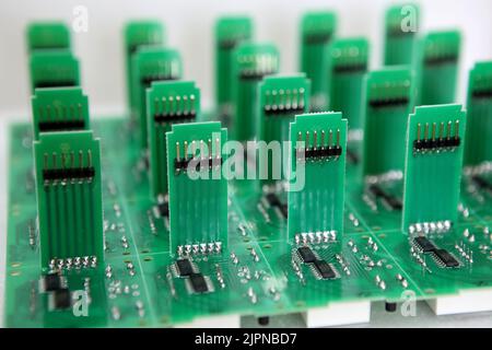 Lots of radios. Loose electronic parts on the table. Digital indicator, LEDs, capacitor and microcircuits in a pile. Stock Photo