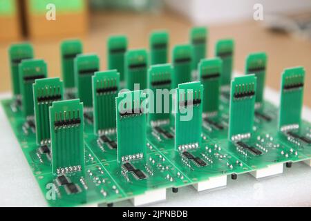 Lots of radios. Loose electronic parts on the table. Digital indicator, LEDs, capacitor and microcircuits in a pile. Stock Photo