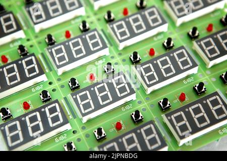 Lots of radios. Loose electronic parts on the table. Digital indicator, LEDs, capacitor and microcircuits in a pile. Stock Photo