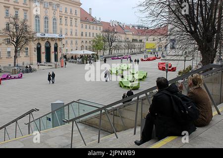 Vienna, Austria - 15 April 2012: People at the MuseumsQuartier. Tourists are resting on the stairs. Urban lifestyle Stock Photo