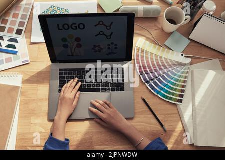 Web designer working on new logotype for a company, view from above Stock Photo