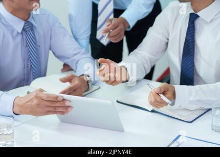 Close-up image of business executives discussing document Stock Photo