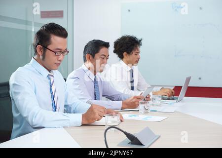 Team of business people busy with work in office Stock Photo