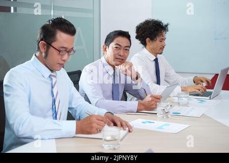 Portrait of entrepreneur working on tablet computer in office Stock Photo
