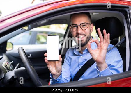 Man Hand Showing Mobile Phone In Car Stock Photo