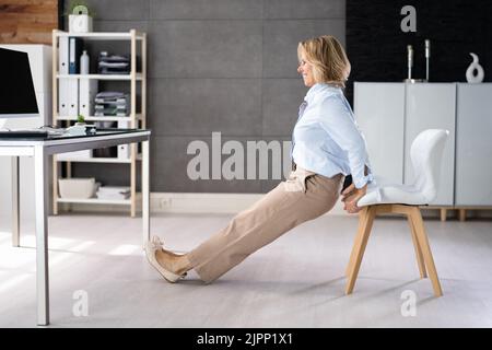 Chair Triceps Dip In Office. Workout Exercise At Desk Stock Photo