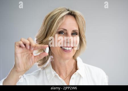 General Pharmacy Pill. Happy Woman Taking Tablet To Control Pain Stock Photo