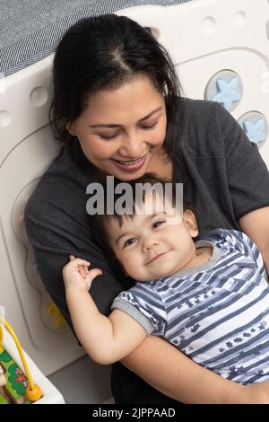 11 month old baby boy at home portrait with loving mother Stock Photo