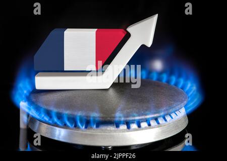 Gas price. Rise in gas prices in France. A burner with a flame and an arrow up, painted in the colors of the France flag. The concept of rising gas or Stock Photo
