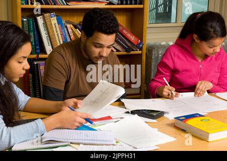 Education High School classroom mathematics or science, male and female students working with graphs or charts during class Stock Photo