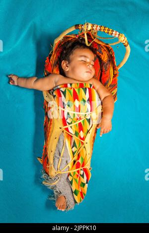 Native American Baby, from the Santa Clara Pueblo of New Mexico, sleeping in a traditional cradleboard, Stock Photo