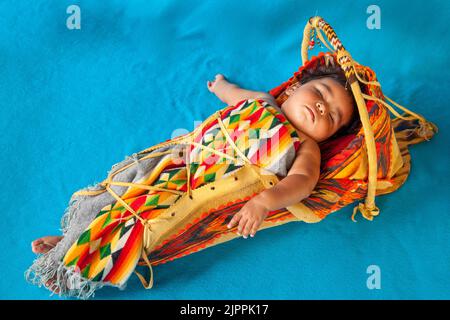 Native American Baby, from the Santa Clara Pueblo of New Mexico, sleeping in a traditional cradleboard, Stock Photo