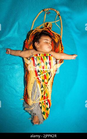 Native American Baby, from the Santa Clara Pueblo of New Mexico, sleeping in a traditional cradleboard, Stock Photo