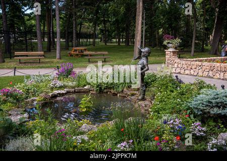 A fountain of a little boy holding a boot at the Assiniboine Park in Winnipeg Stock Photo