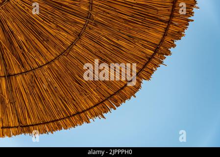 Bamboo beach umbrella isolated on white. Clipping Path included