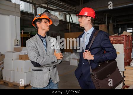 two engineers at the construction site discuss the work to be done, colleagues during work Stock Photo