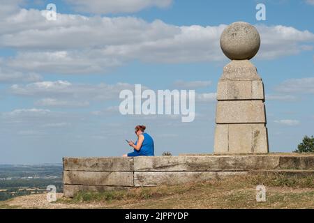 Coombe Hill, Buckinghamshire, UK. 19th August, 2022. People take in the views from Coombe Hill at Butler's Cross today on another warm but windy day as the ongoing drought continues. Credit: Maureen McLean/Alamy Live News Stock Photo