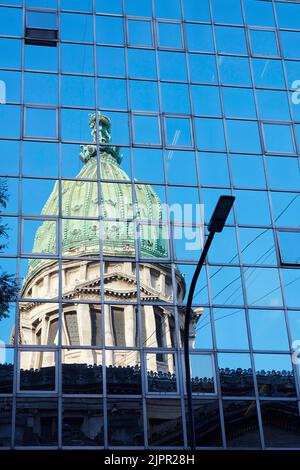 The dome of the National Argentine Congress is reflected in a building window, Monserrat, Buenos Aires, Argentina. Stock Photo