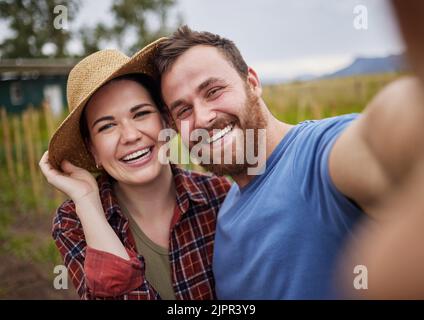 Smile, selfie and nature of happy couple in the countryside smiling, bonding and taking a photo together. Smiling man and woman embracing life, love Stock Photo