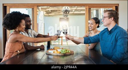Double date of couples having dinner together and drinking wine at a restaurant celebrating and having fun. Romantic group of friends enjoying a lunch Stock Photo