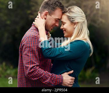 Love is such a wonderful feeling. an affectionate young couple spending quality time together outdoors. Stock Photo