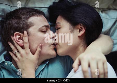 Your kisses take my breath away. a loving young couple relaxing at home. Stock Photo