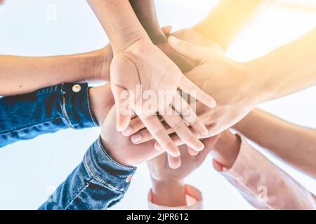 Close up view of young business people putting their hands together - Stack of hand - Unity and teamwork concept Stock Photo
