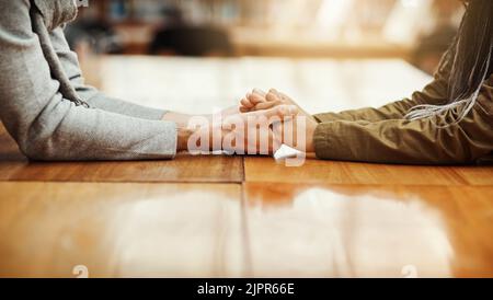 Well get through this together. an unrecognizable university student consoling another student while sitting in the library. Stock Photo